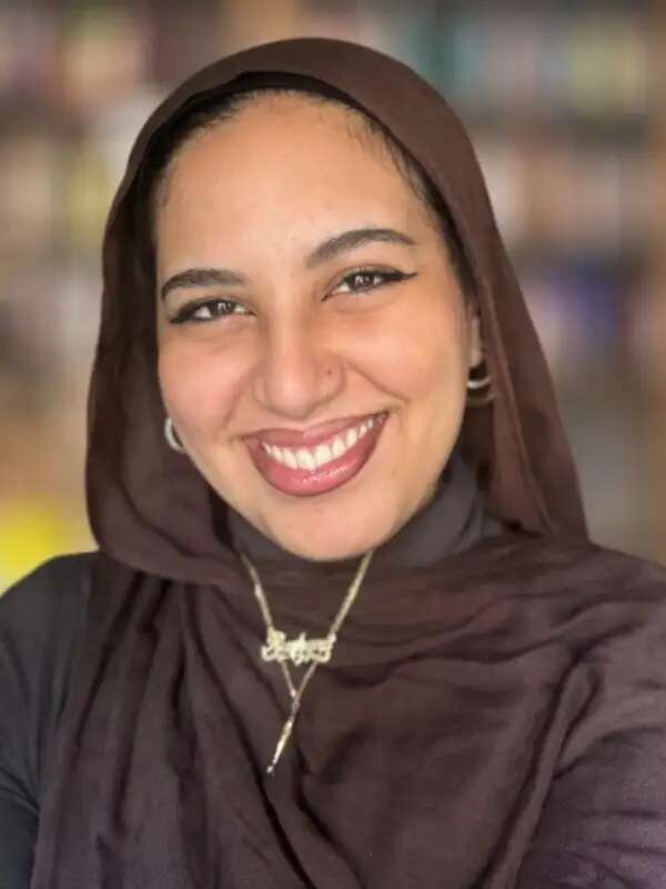 Girl with hijab smiling at camera