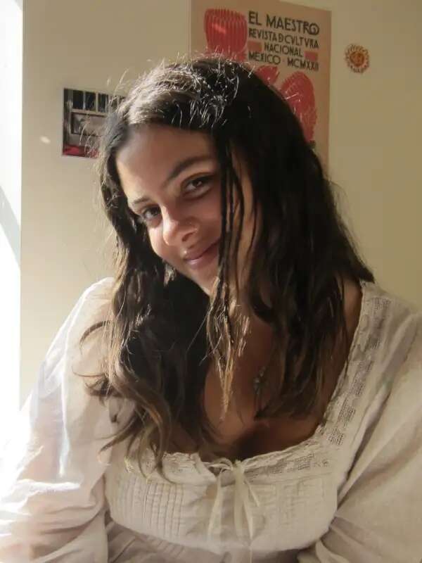 Photo of girl smiling at camera with head tilted